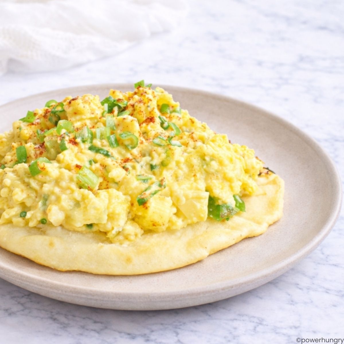 chickpea flour tofu egg salad on a piece of naan