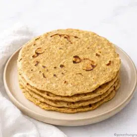 stack of chickpea flour tortillas on an off-white plate