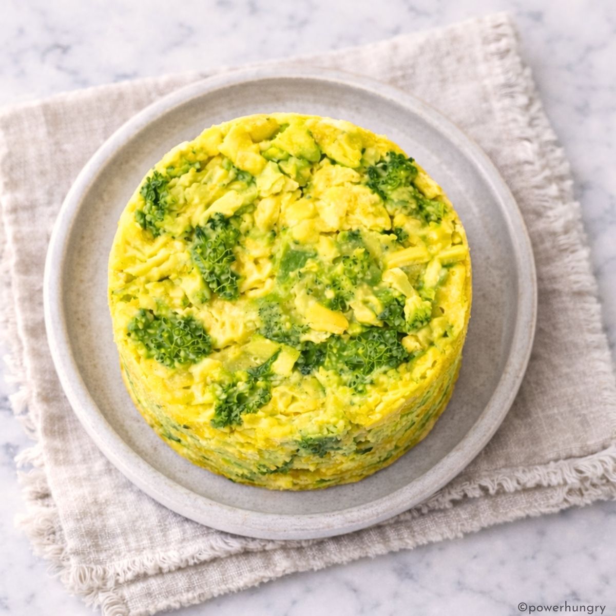 a single vegan broccoli rice casserole muffin on a plate