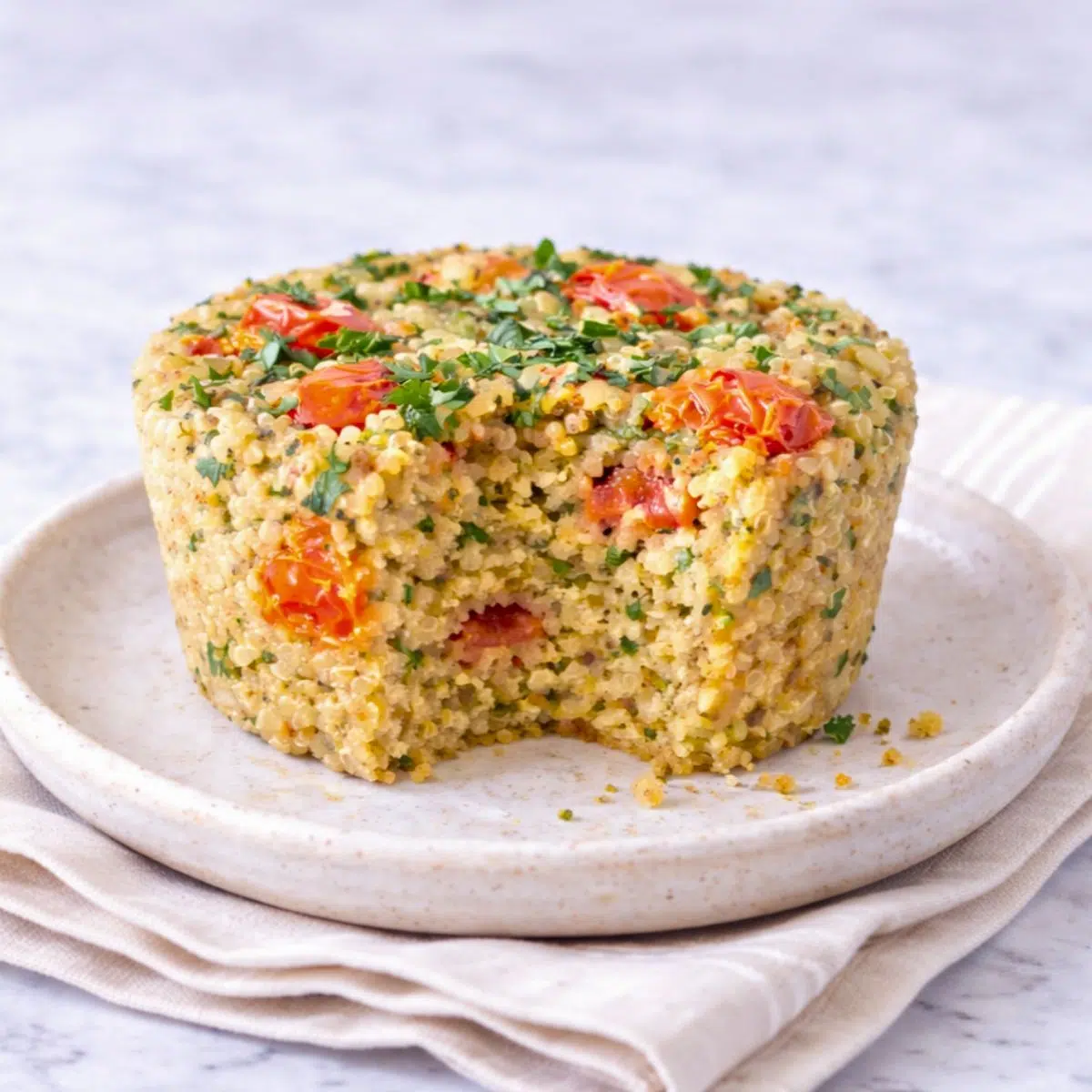 chickpea flour quinoa muffin with a bite taken out