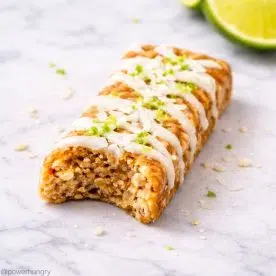 a lime coconut protein bar on marble surface