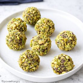 chocolate pumpkin protein balls on a white plate