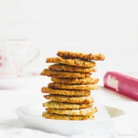 2 ingredient coconut banana cookies stacked on a white napkin