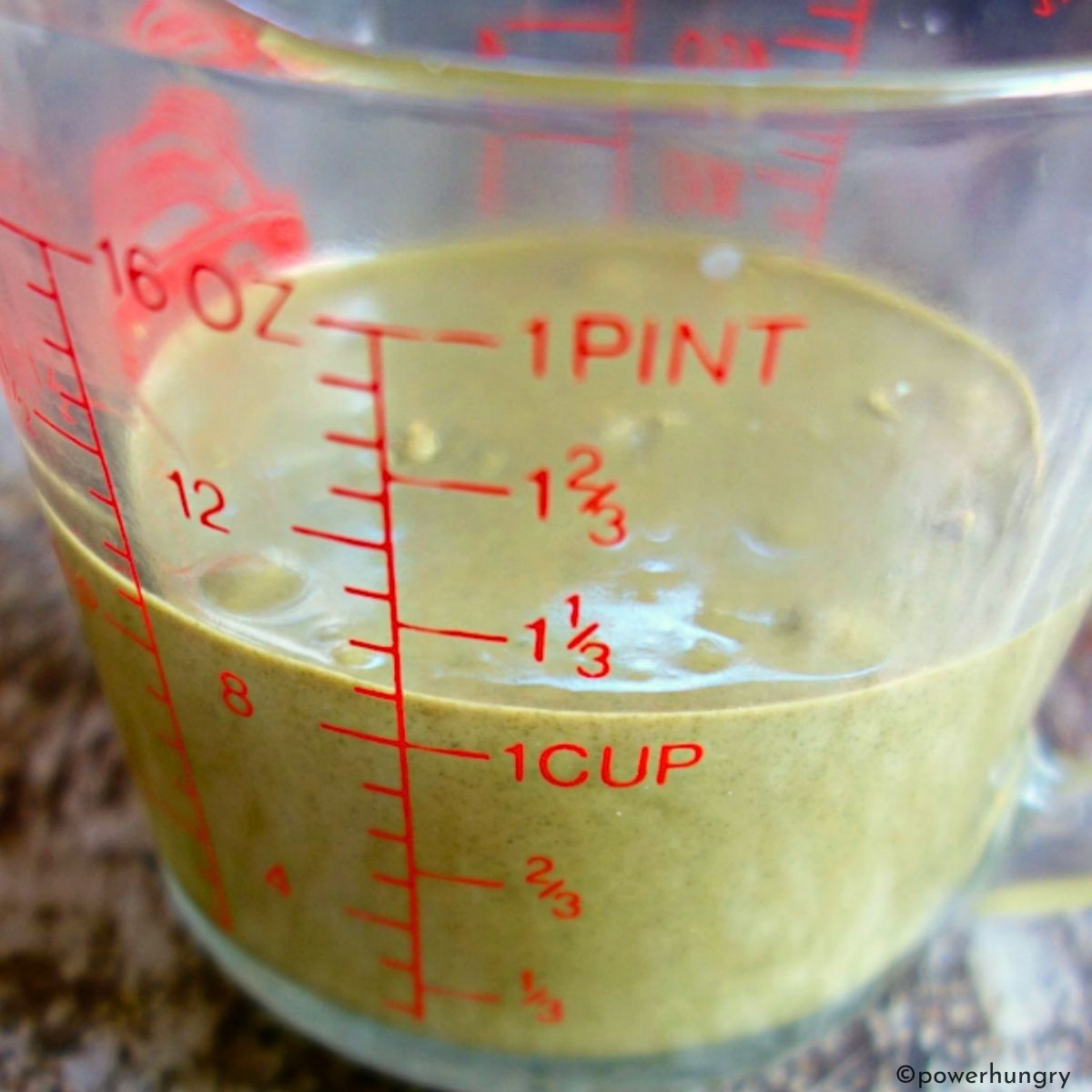 measuring cup full of pumpkin seed butter