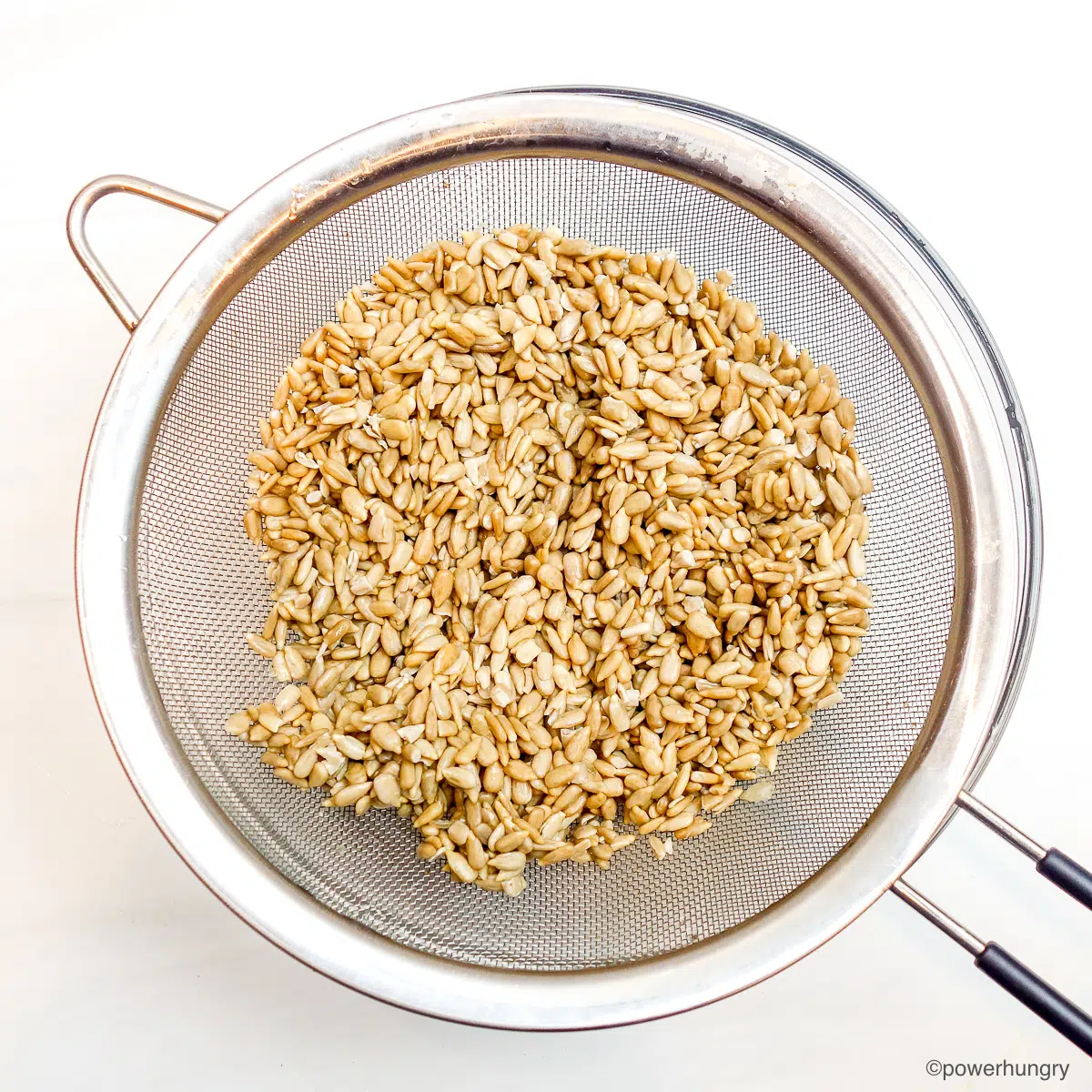 sunflower seeds, drained and rinsed, in a mesh sieve