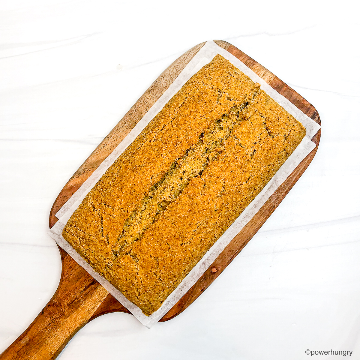 overhead shot of high protein bread on a wood cutting board