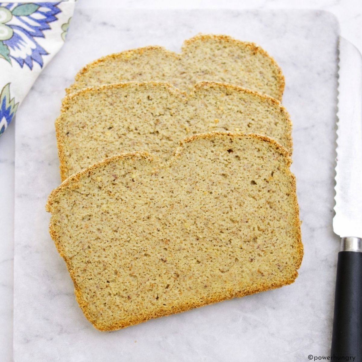 slices of high protein millet bread on cutting board
