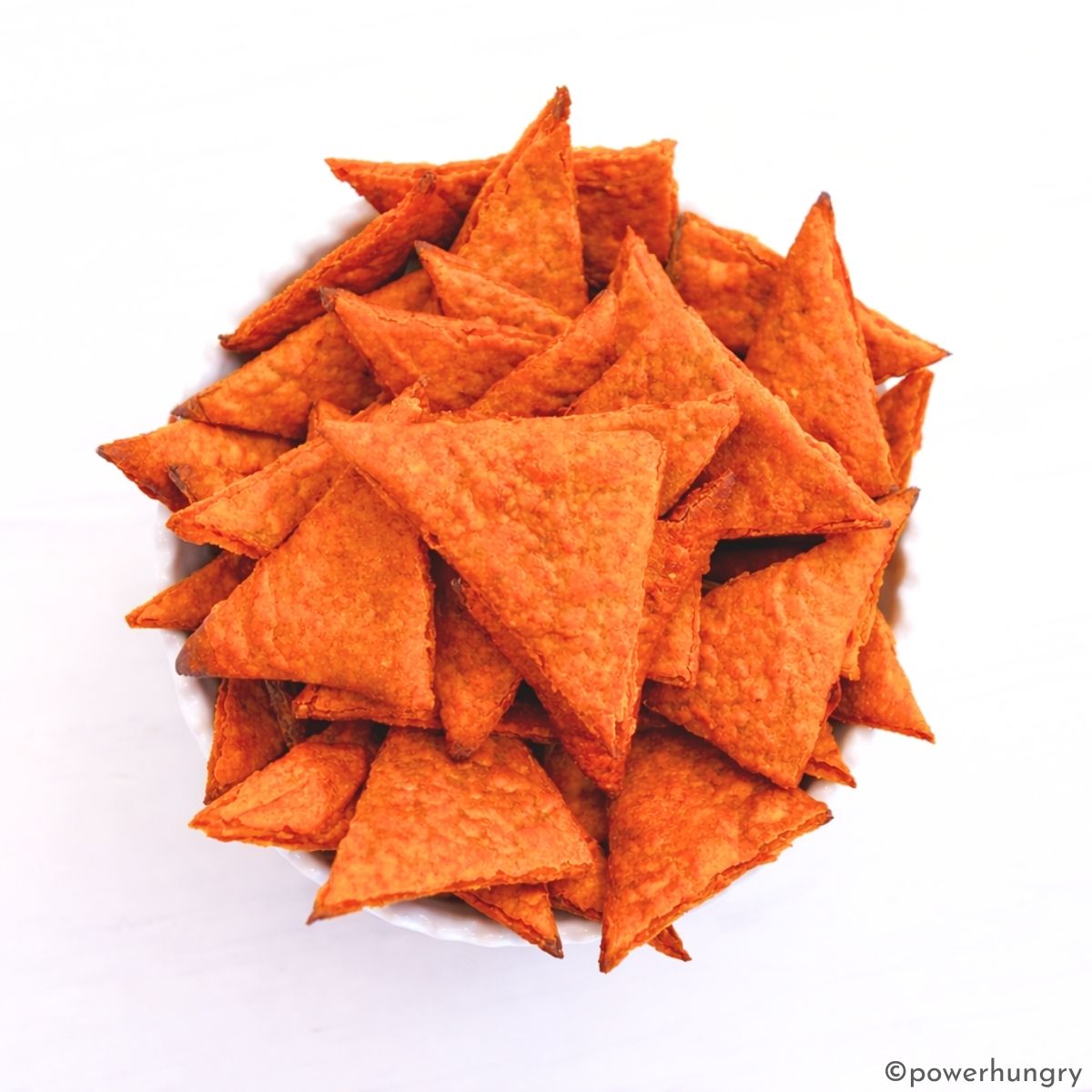 a white bowl filled with high-protein lentil chips