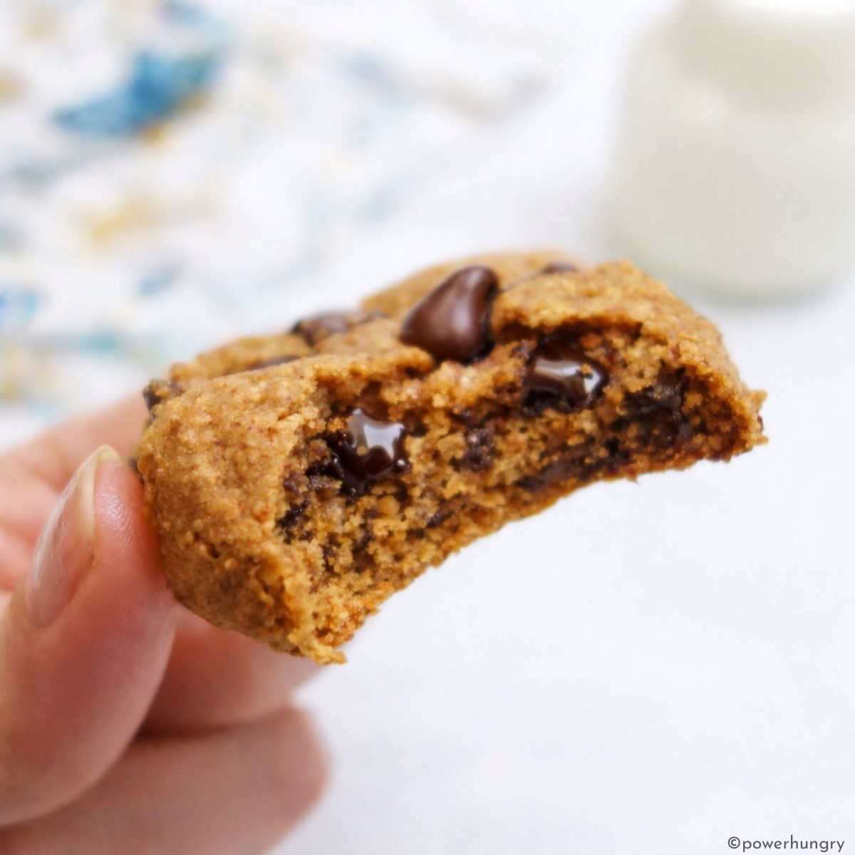 single chocolate chip cookie with a bite showing interior