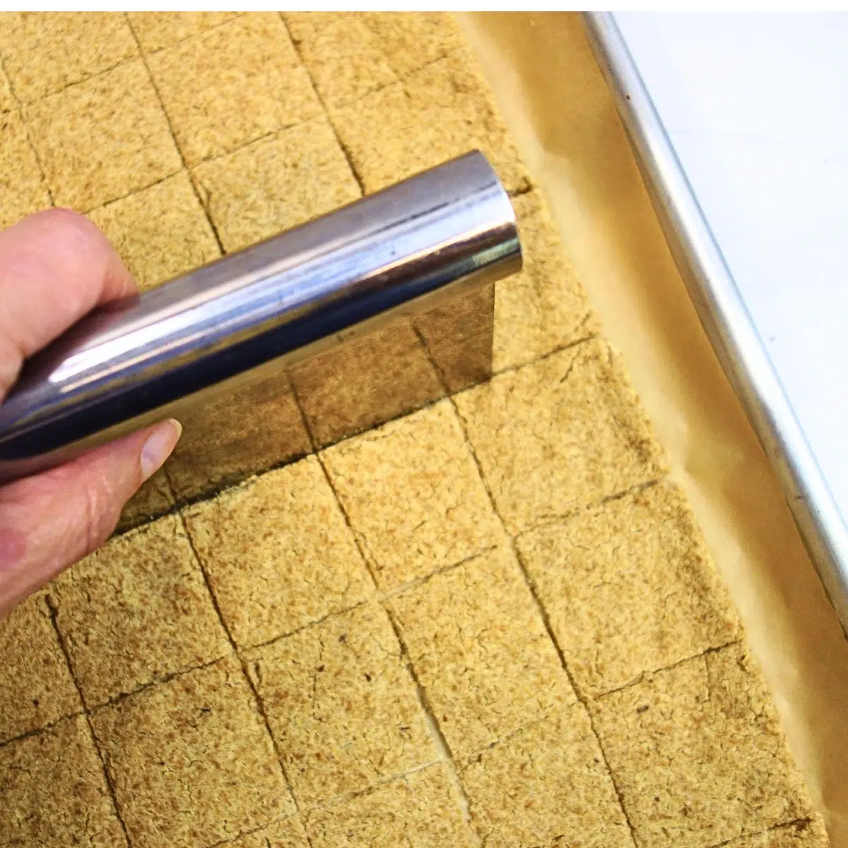 cutting the chickpea flour crackers after first bake