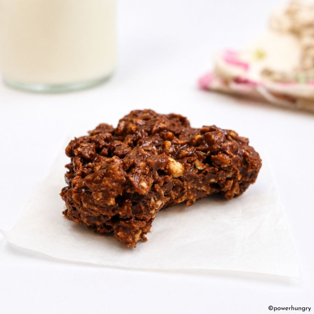 a single chocolate no-bake protein cookie on a piece of parchment paper