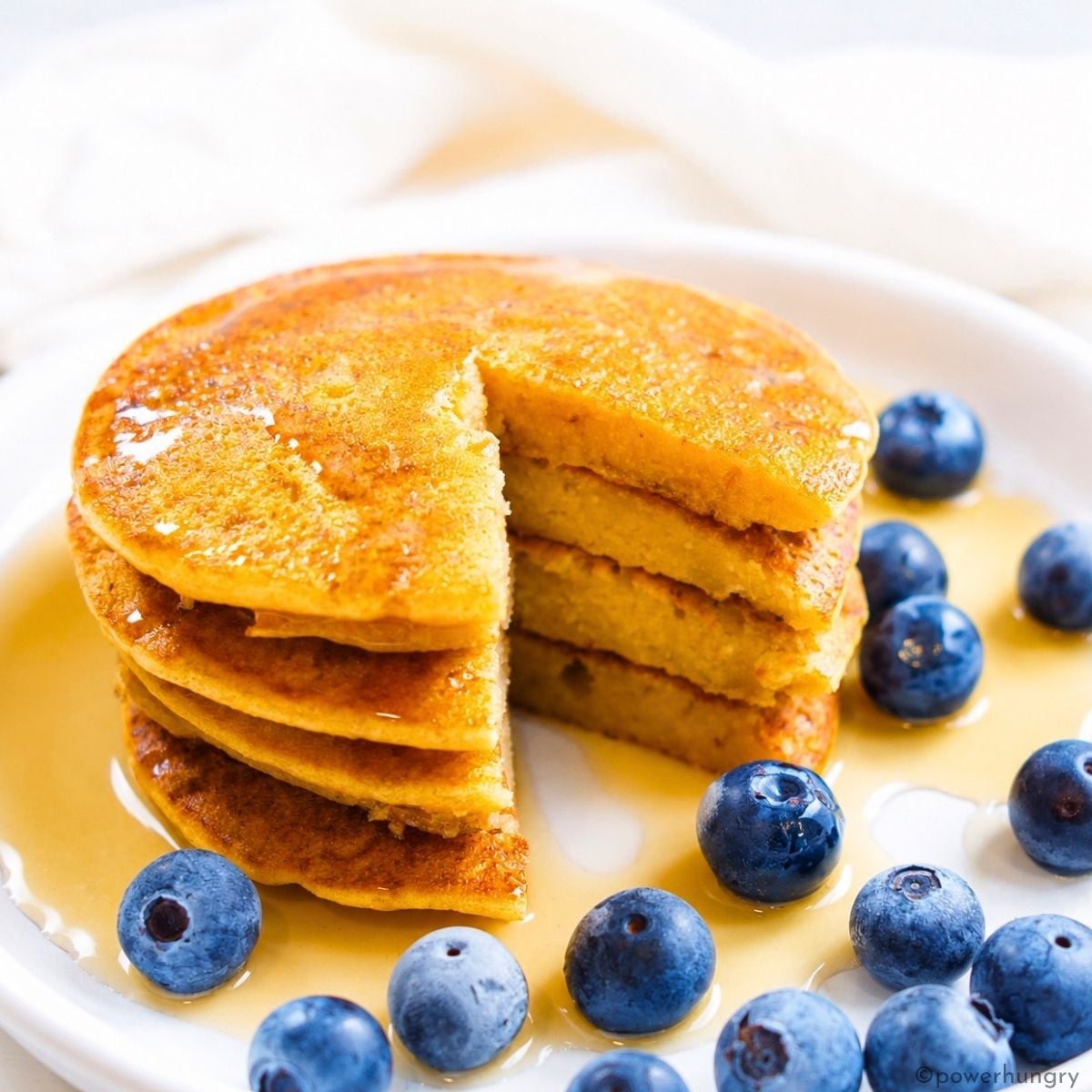 stack of red lentil pancakes with maple syrup